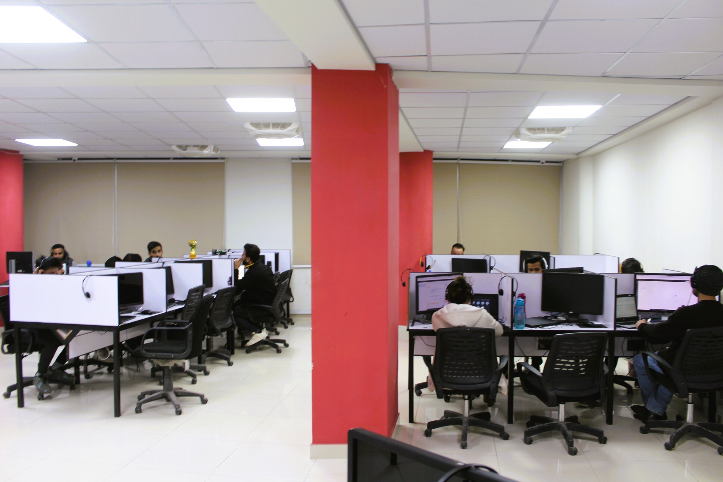 Agents working at workstations on the production floor